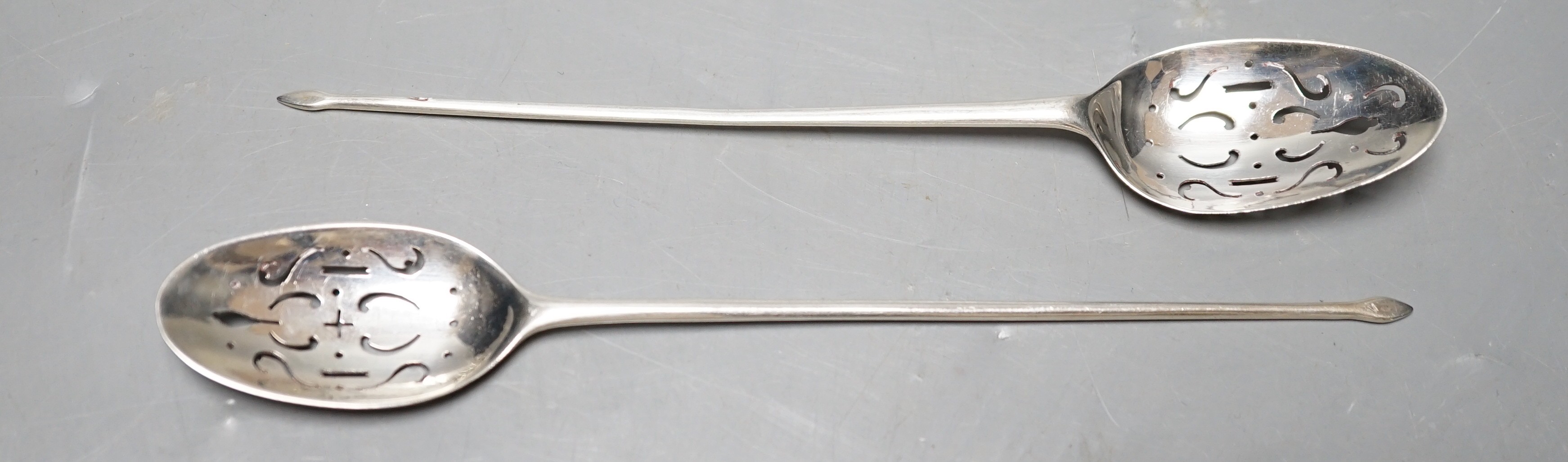 Two 18th century silver mote spoons, including one by Nicholas Hearnden, London, circa 1760, 14.5cm, marks rubbed on the other spoon.